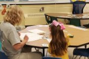  Pre-K Teacher and Student at Table